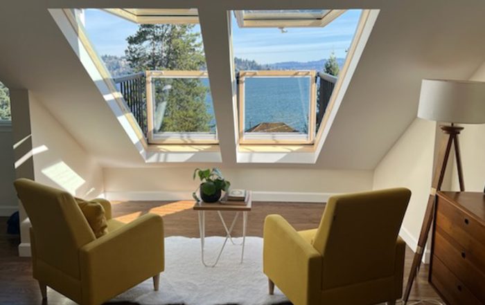 two large skylights with two chairs looking out them